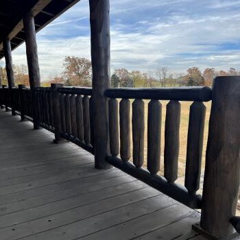 custom made log railing on the deck of a log cabin, handcrafted log railing from LogHeads Home Center Log Furniture & Log Railing Manufacturing Company.