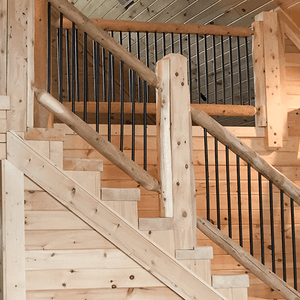 Log Railing with Black Powder Coated Balusters in a log cabin from LogHeads Home Center Located in Lancaster Kentucky