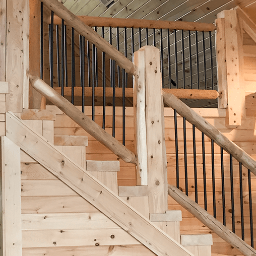 Log Railing with Black Powder Coated Balusters in a log cabin from LogHeads Home Center Located in Lancaster Kentucky