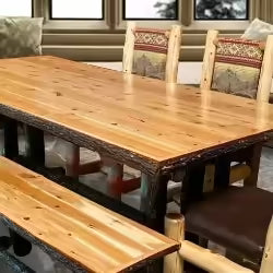 Rustic Dining Room Furniture including a wooden Farmhouse Dining Table, our  Signature Log Dining Table, accompanied by solid wood log chairs with rustic patterns and leather embroidery