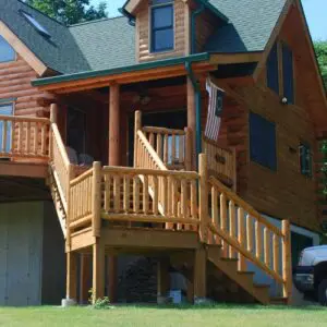 an outdoor stairway made of log railing on a large log home